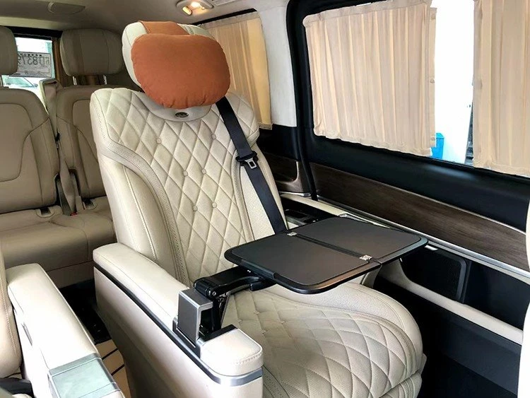 Folding table board installed on the armrest of individual seat in van 2